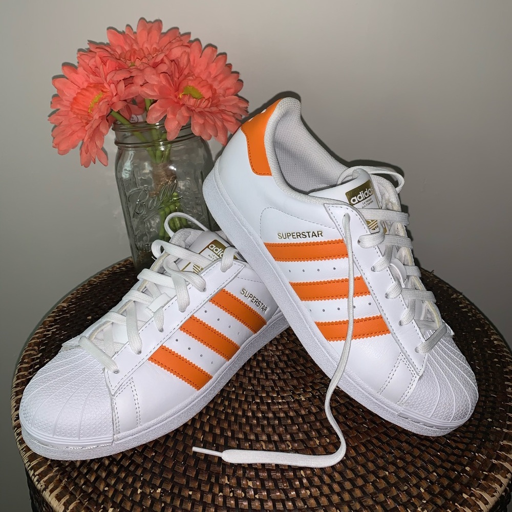 White and Orange Adidas Superstar sneakers